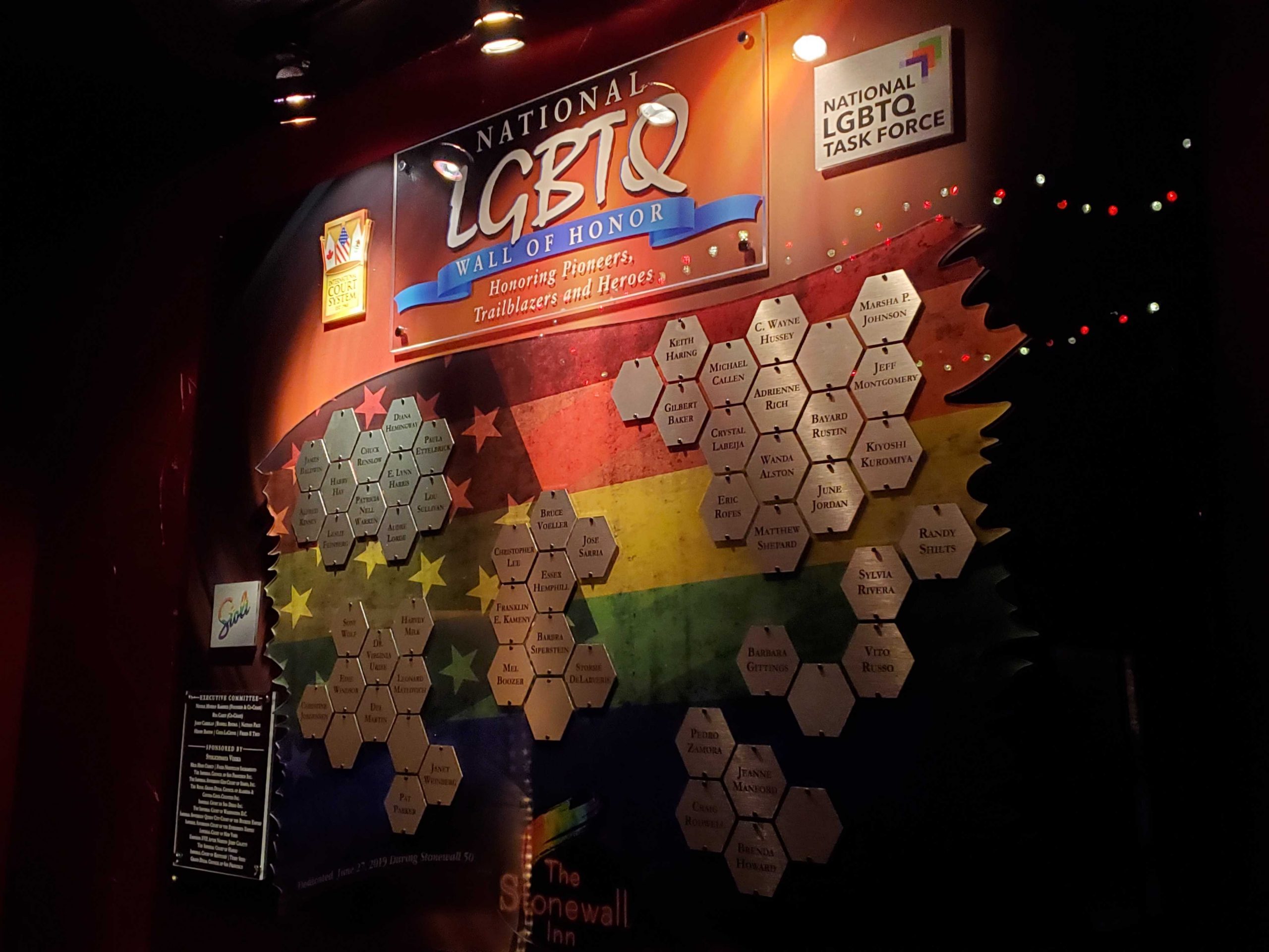 The National LGBTQ Wall of Honor, a wall painted with the rainbow flag and covered with hexagonal plaques listing the names of LGBTQ pioneers, trailblazers, and heroes.