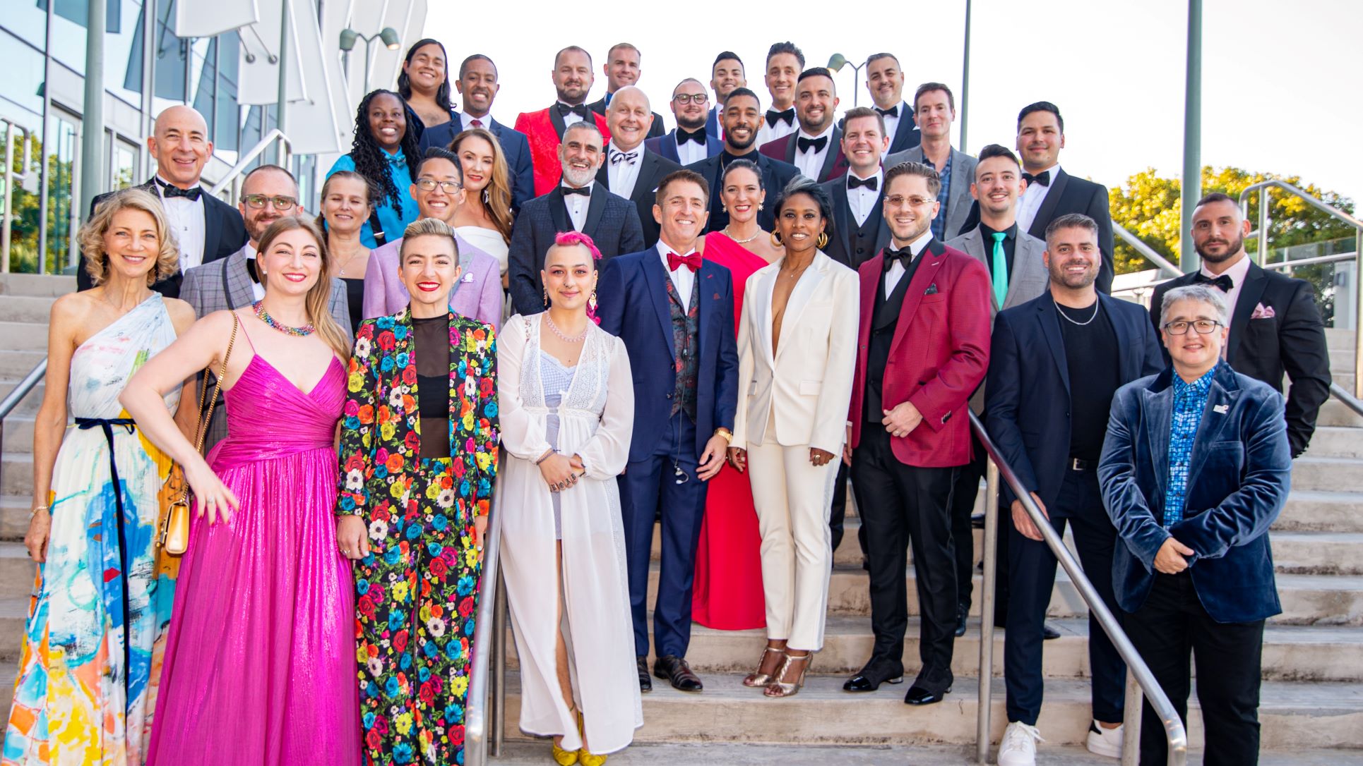 A large group of people standing on a set of stairs at the Task Force Gala.