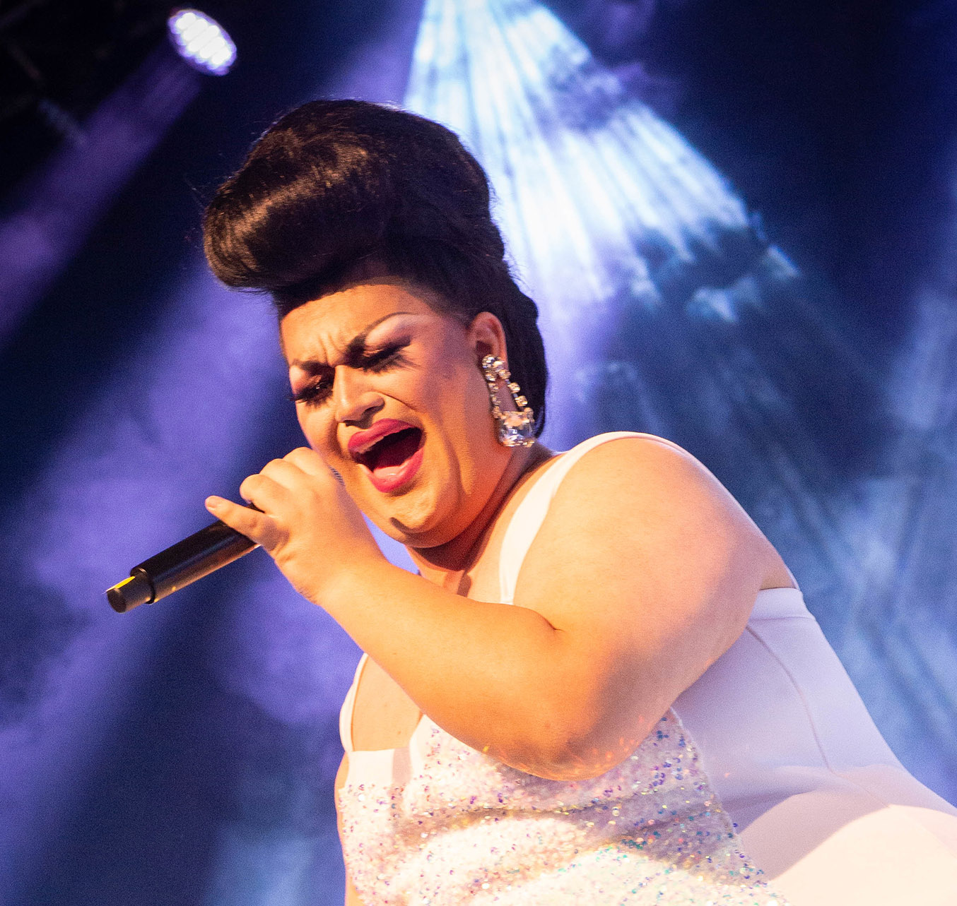 A person sings passionately into a microphone at the 2022 Task Force Gala.