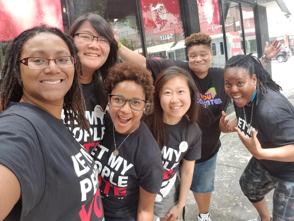 Group of Black and API queer women posing together for a photo during GOTV