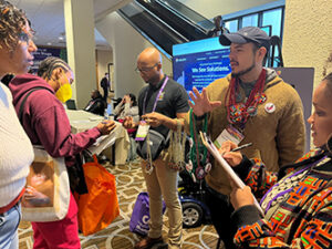 Queer the Vote volunteer sharing information during the Creating Change Conference.