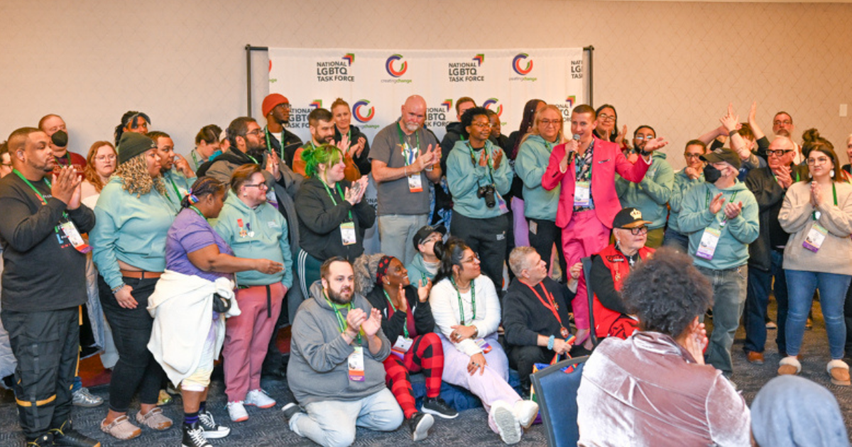 Image of group of Creating Change attendees on a small stage.