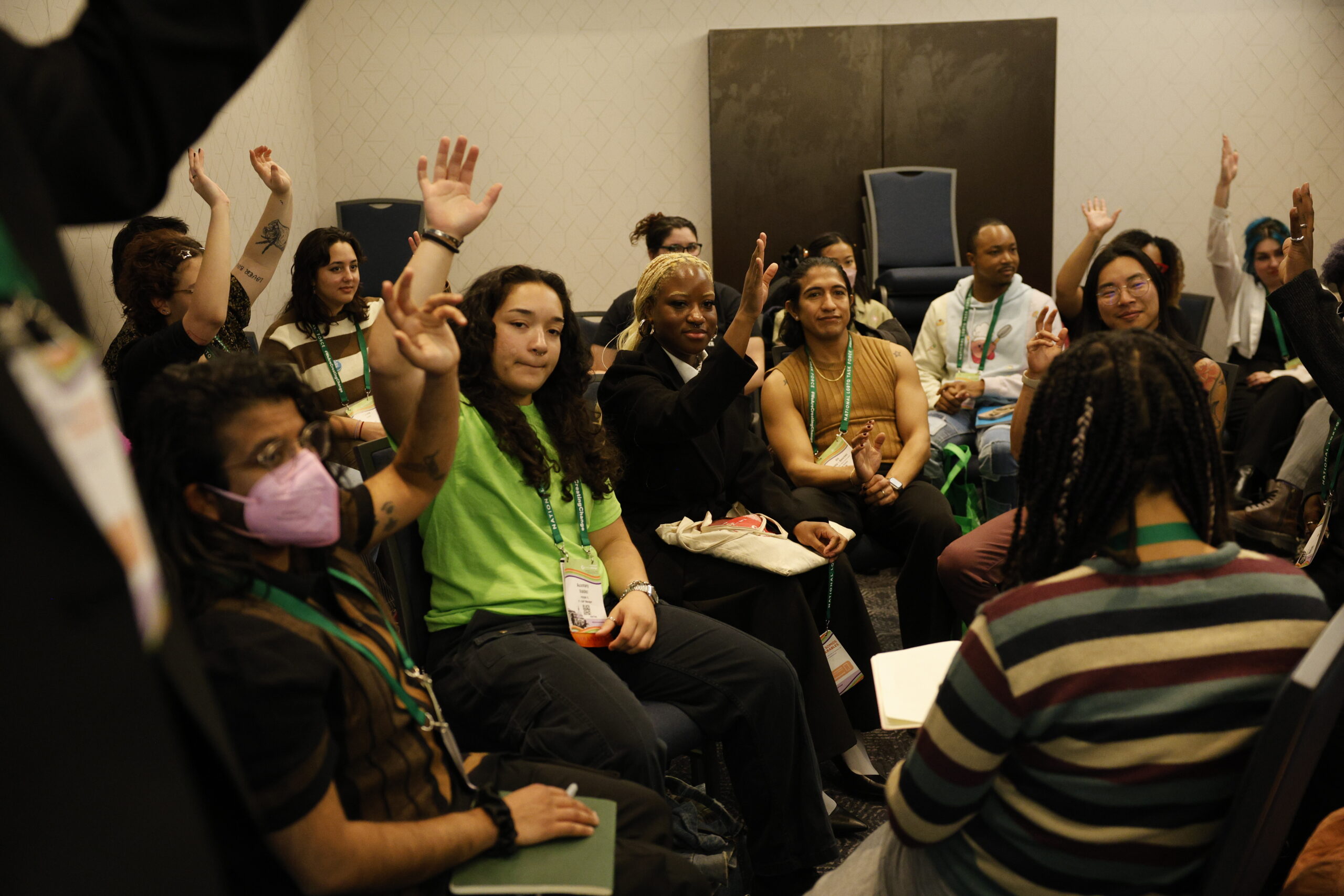 people with raised hands in a room